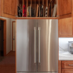 Cabinet open above refrigerator